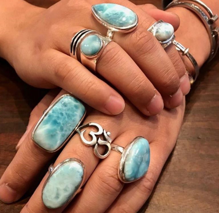 Sterling silver rings set with sky-blue larimar, worn across two hands