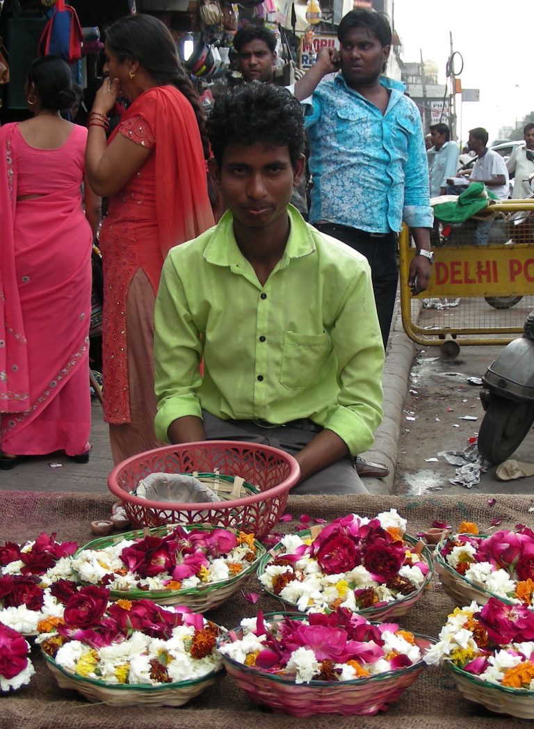 Flower sellers with baskets of rose and marigold offerings