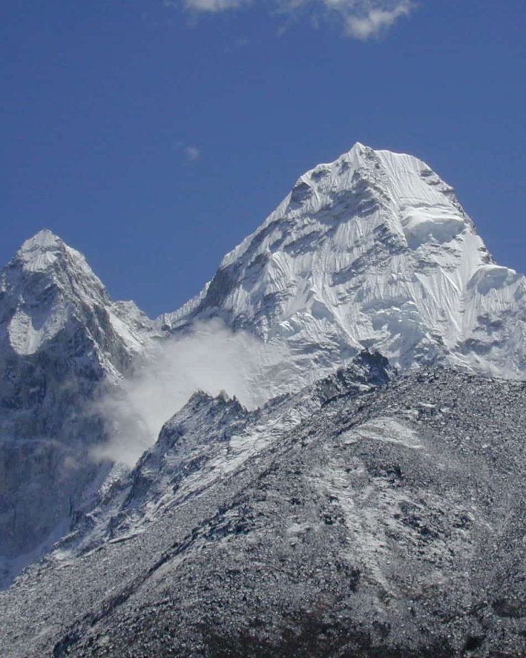 Snow-capped Himalayan summit against a deep blue sky