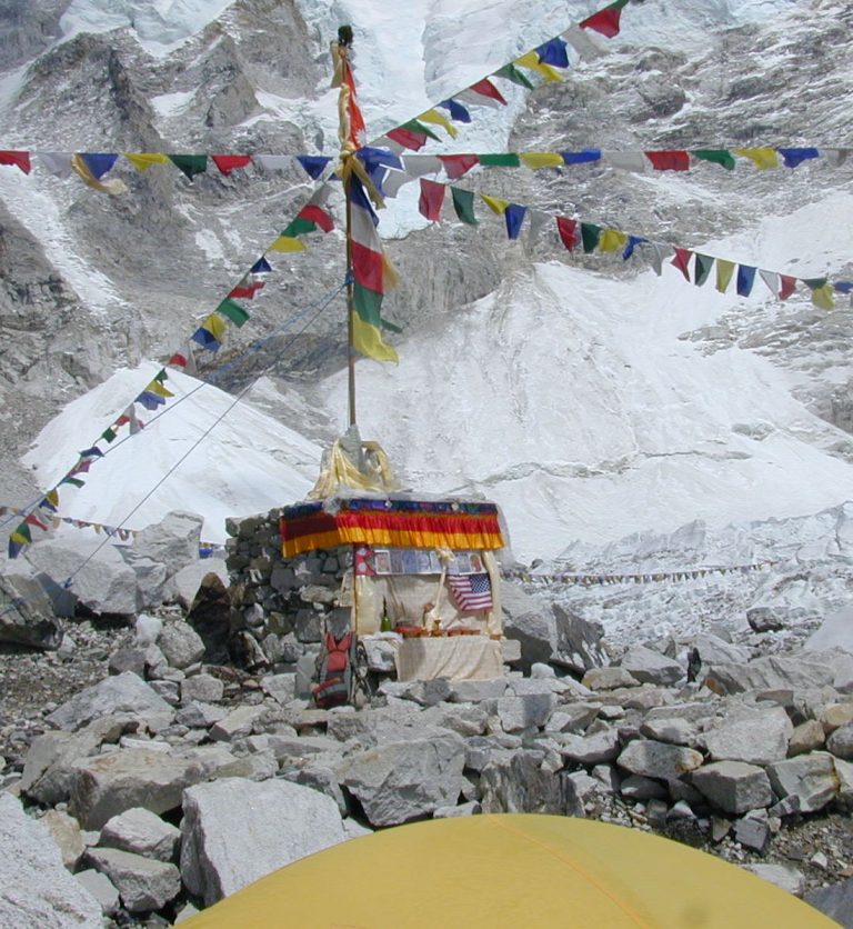 Prayer flags strung over a rocky camp in the Everest region