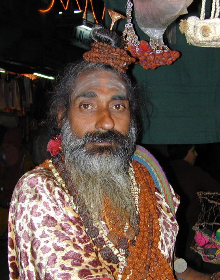 Sadhu in leopard-print robes strung with rudraksha malas