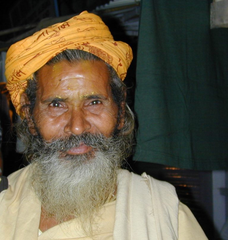 Portrait of a golden-turbaned sadhu with a silver beard